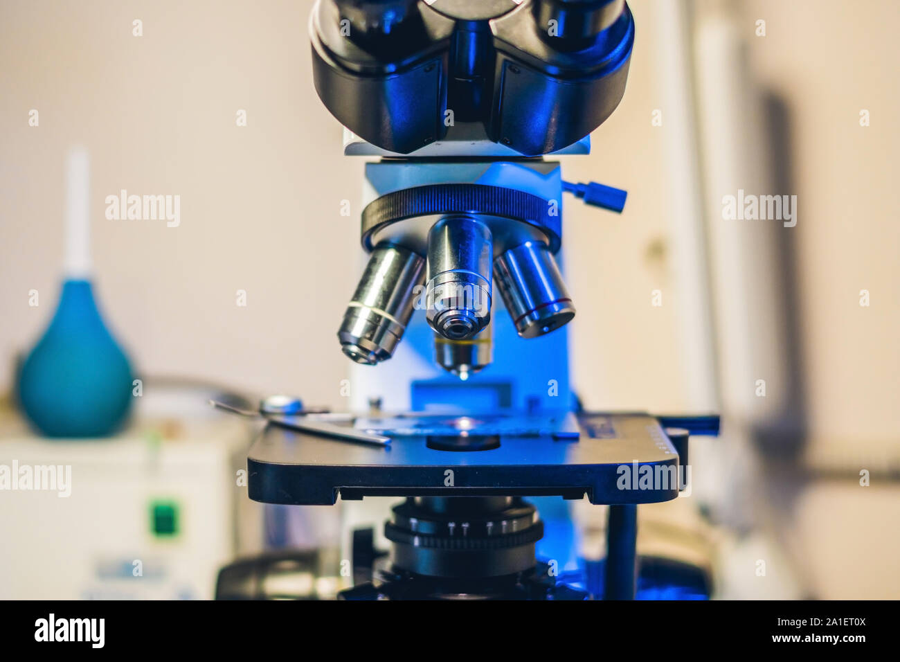 Optical microscope with four different objective lenses. Stock Photo