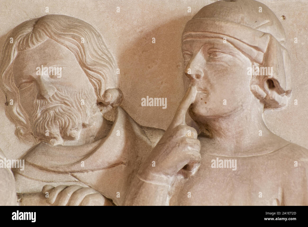 Active Learning (a scholar with a finger on his lips listening with attention and reflecting) - Detail of the Cino da Pistoia's tomb - Duomo - Pistoia Stock Photo
