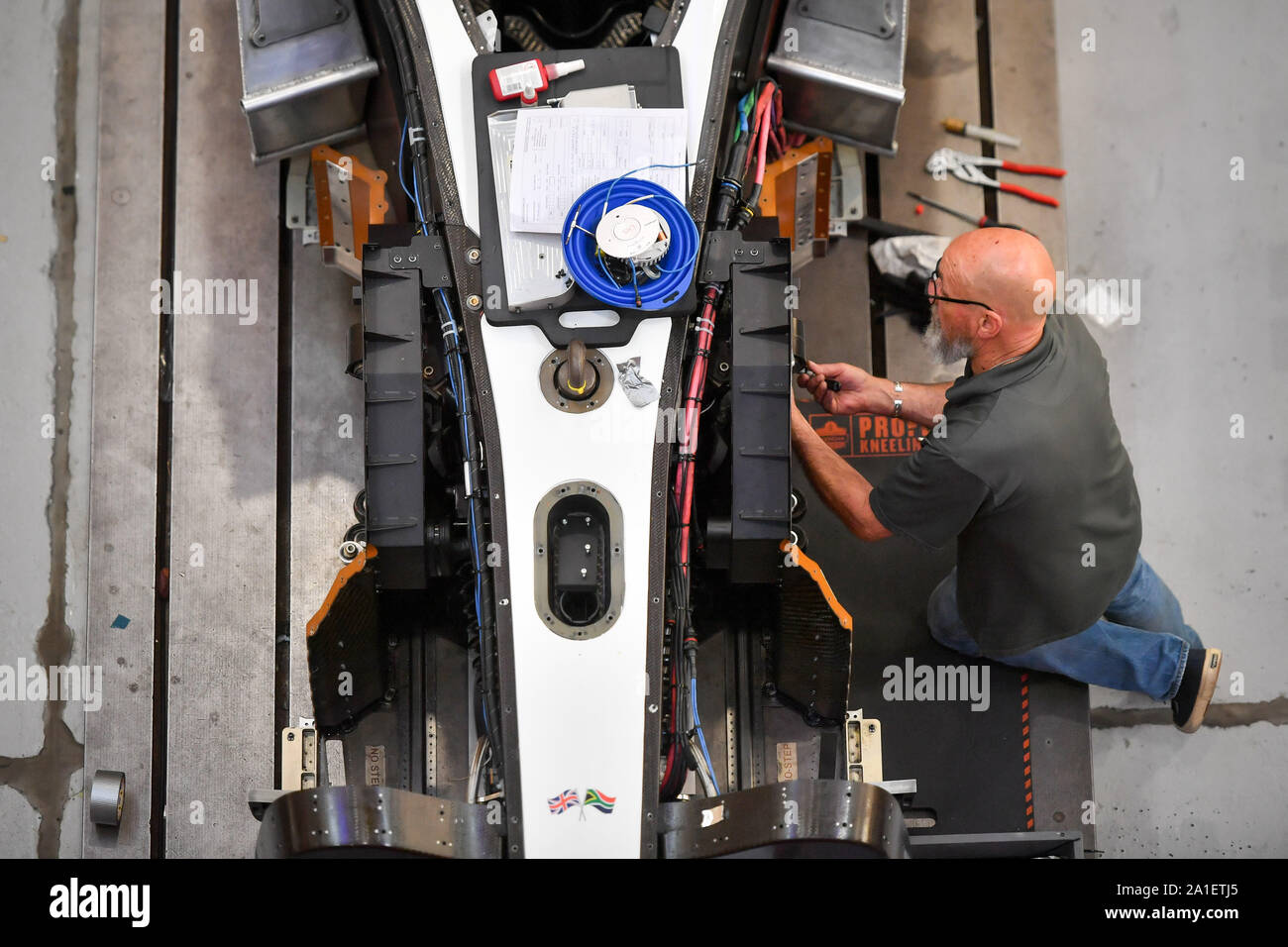 An engineers works on the front wheel section of Bloodhound as it enters the final build phase at Gloucestershire Science and Technology Park, Berkeley, before it heads off to South Africa for testing ahead of a land speed record attempt. Stock Photo