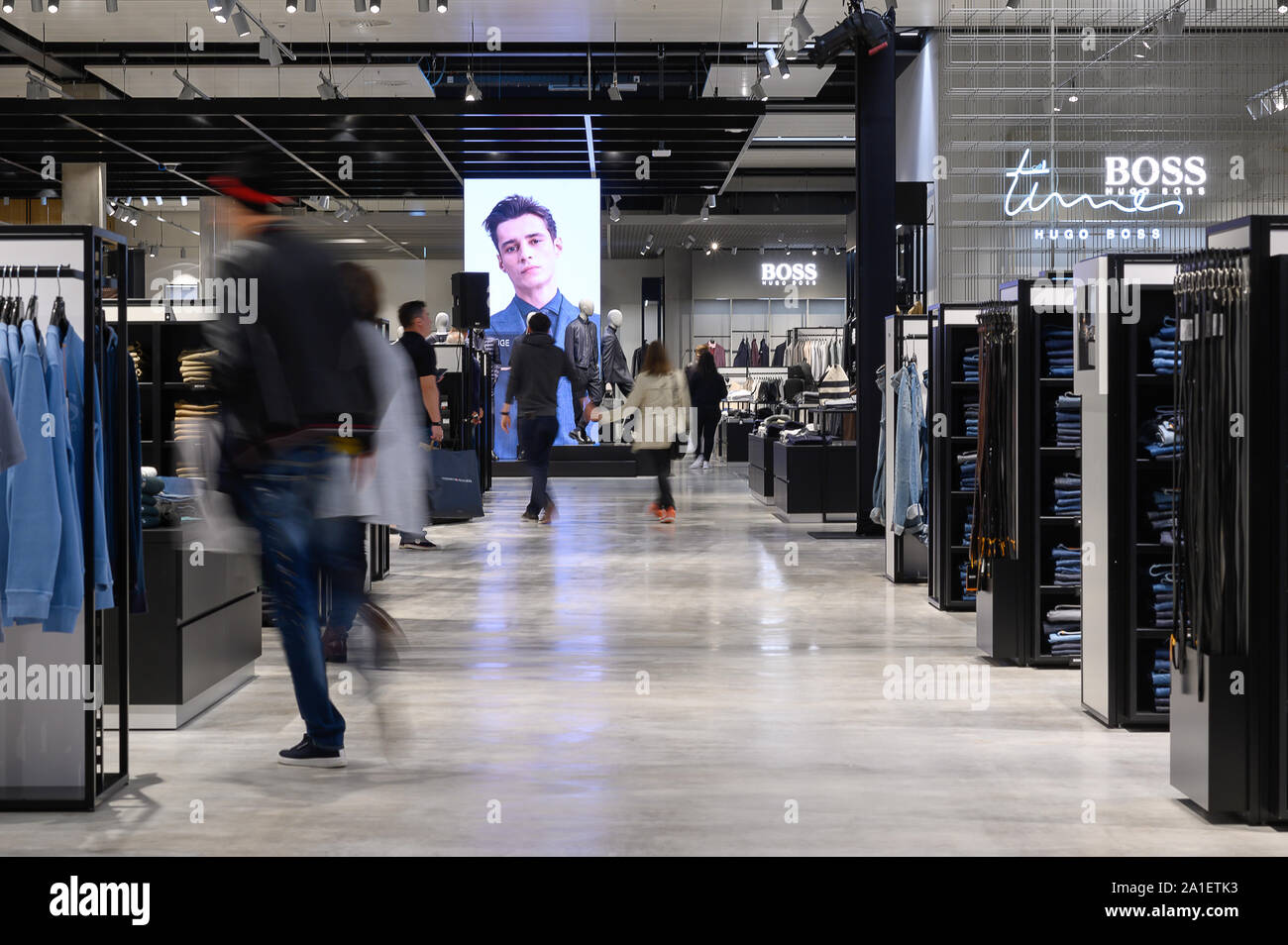 26 September 2019, Baden-Wuerttemberg, Metzingen: Visitors walk through the  new flagship outlet of Hugo Boss in the Outlet-City. The outlet will  officially open on 26 September. Photo: Sebastian Gollnow/dpa Stock Photo -