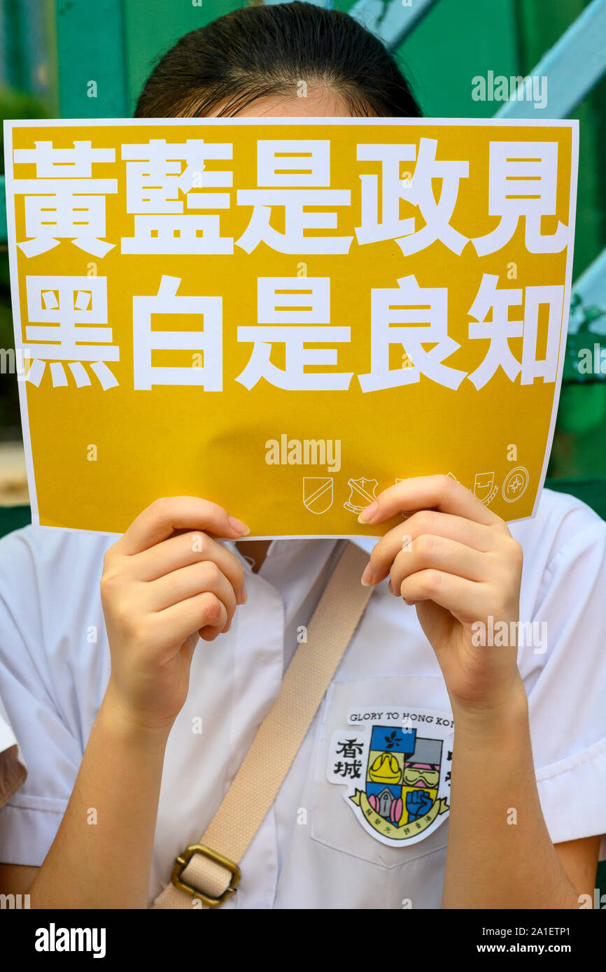 Wan Chai Hong Kong September 26 2019.  Dozens of high school students formed a human chain and hung banners and posters on Queens Rd West.  Student protesters hold signs. Stock Photo