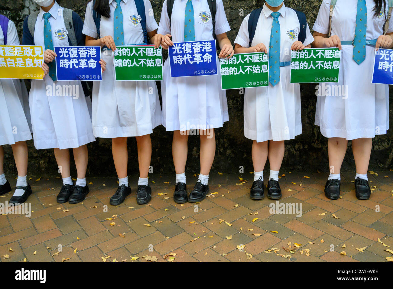 Wan Chai Hong Kong September 26 2019.  Dozens of high school students formed a human chain and hung banners and posters on Queens Rd West.  Student protesters hold signs. Stock Photo