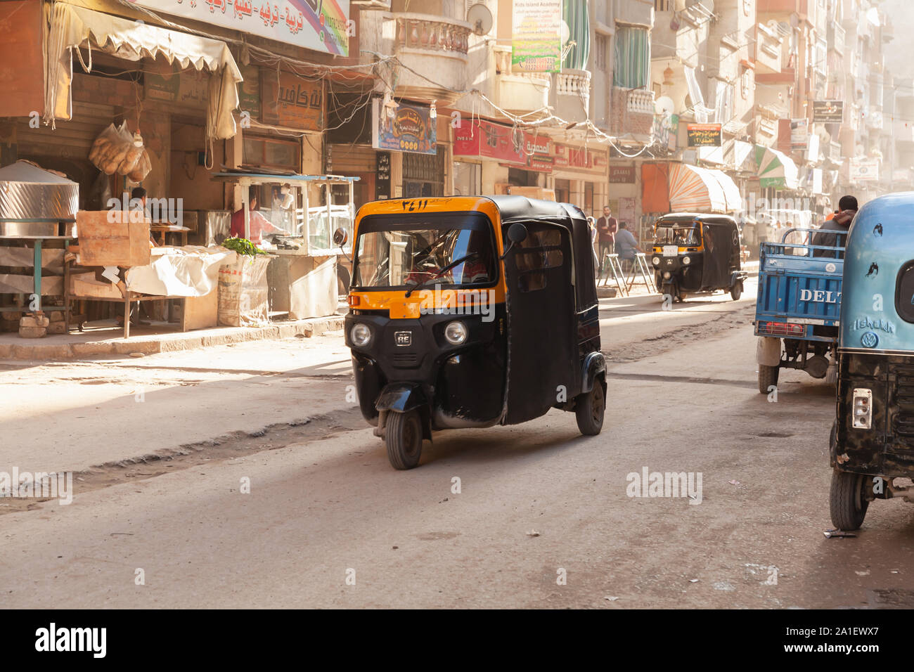 Alexandria, Egypt - December 18, 2018: Street view of Alexandria, auto rickshaw is on the street, ordinary people walk the street Stock Photo