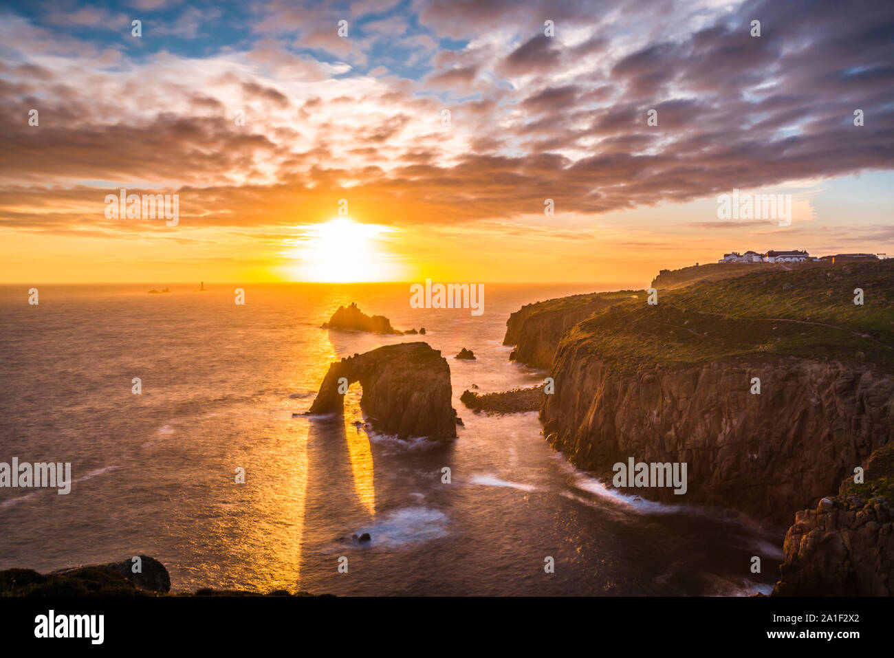 Dramatic sky at sunset with Enys Dodnan and the Armed Knight rock formations at Lands End, Cornwall, England, United Kingdom, Europe. Stock Photo