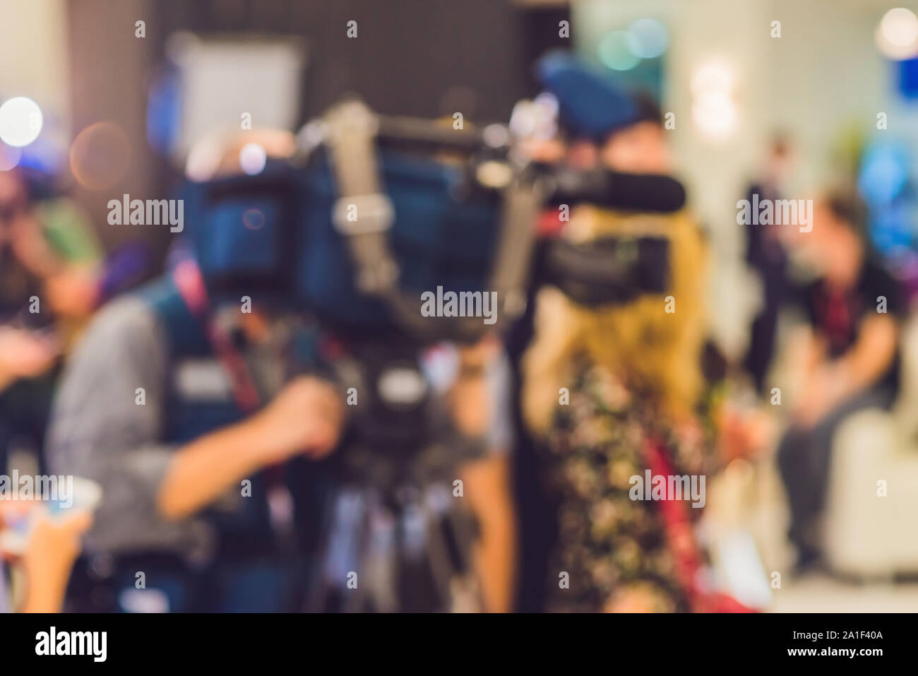 Blurred picture. Journalists interviewed a man. Camera Microphone Stock Photo