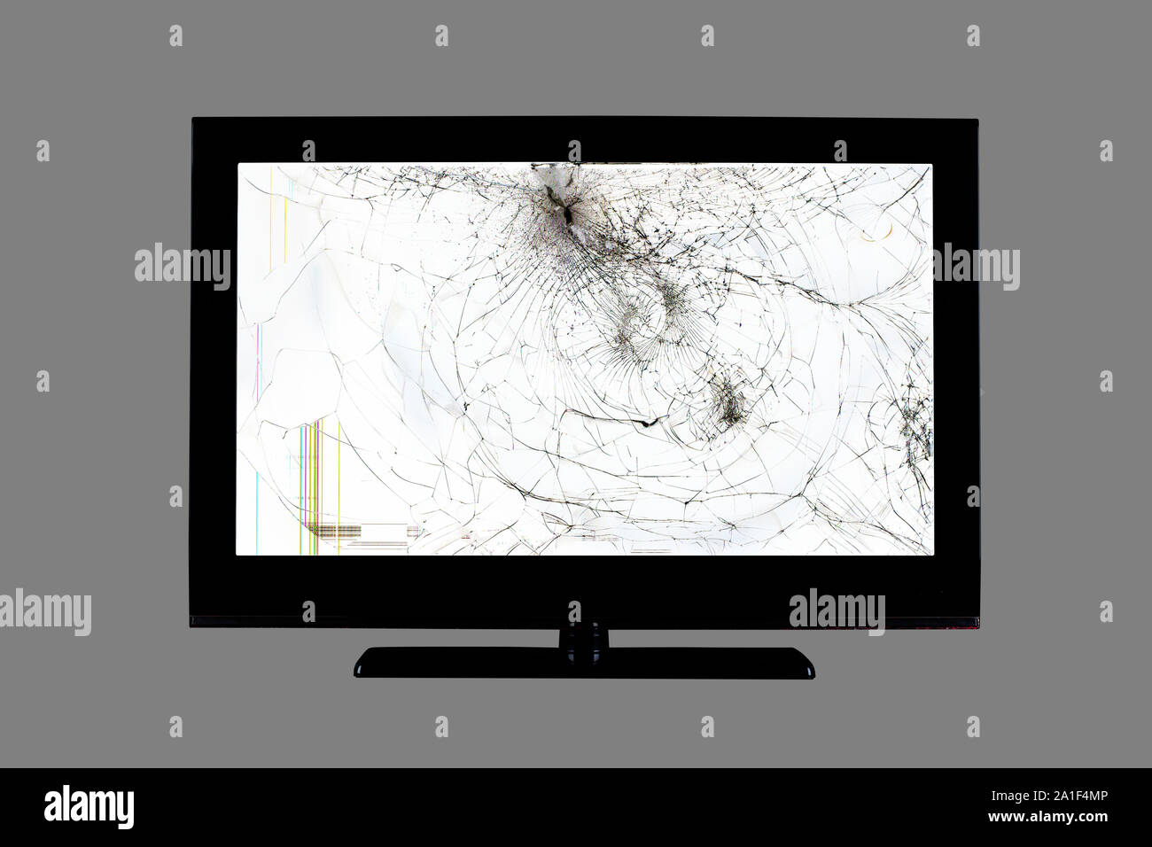 colored stripes and cracks on a black broken screen of a liquid crystal display, computer monitor or full hd television isolated on a grey background Stock Photo