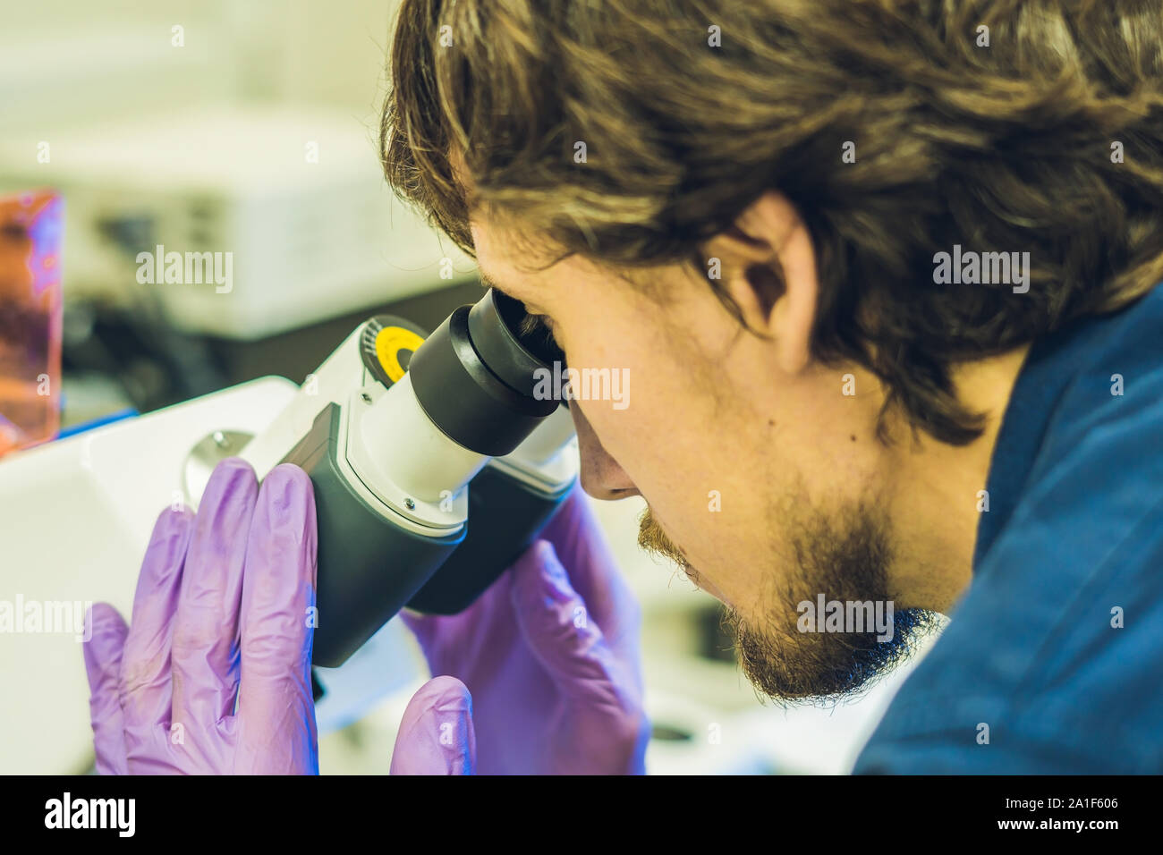 Scientist work on a confocal scanning microscope in a laboratory for biological samples investigation. Stock Photo