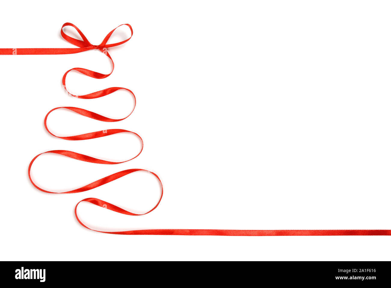 Christmas tree with a bow made of silk red ribbon isolated on white ...