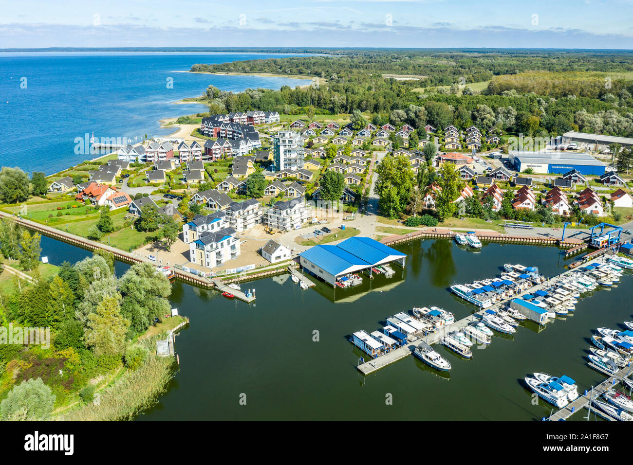 View over marina of village Rechlin towards lake Mueritz,holiday cottages, pleasure boats, Rechlin, Mecklenburg-Vorpommern, Germany Stock Photo