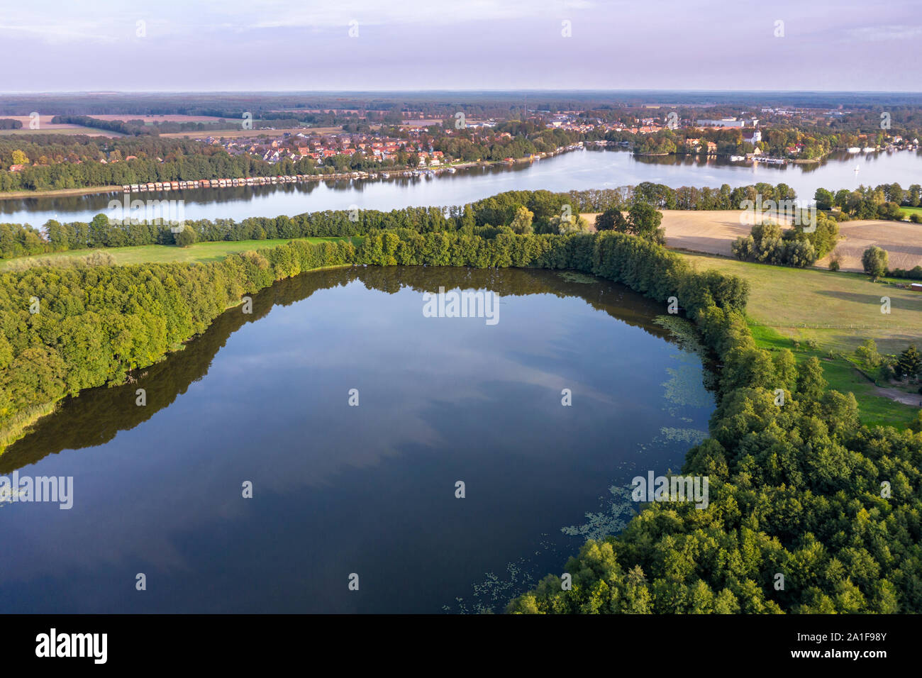 Drone shot, aerial view over  lake Schulzensee to lake Mirow, castle Mirow on island back right, Mecklenburg lake district, Mecklenburg-Vorpommern, Ge Stock Photo