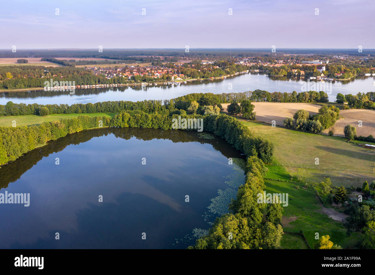 Drone shot, aerial view over  lake Schulzensee to lake Mirow, castle Mirow on island back right, Mecklenburg lake district, Mecklenburg-Vorpommern, Ge Stock Photo