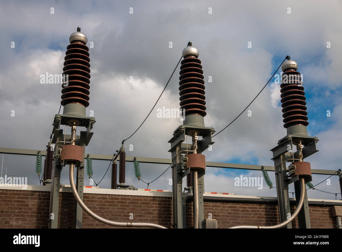 Picture of a high voltage system with ceramic insulators high voltage  in sight at a transformer building to reduce high voltage  from 110000 volts to Stock Photo