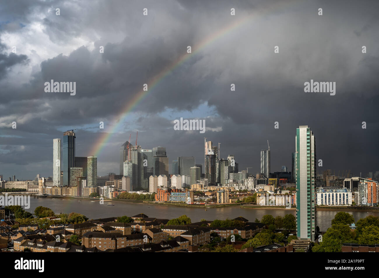 London, UK. 26th September, 2019. UK Weather: A massive rainbow breaks over Isle of Dogs financial district in east London after a brief rainstorm. Credit: Guy Corbishley/Alamy Live News Stock Photo