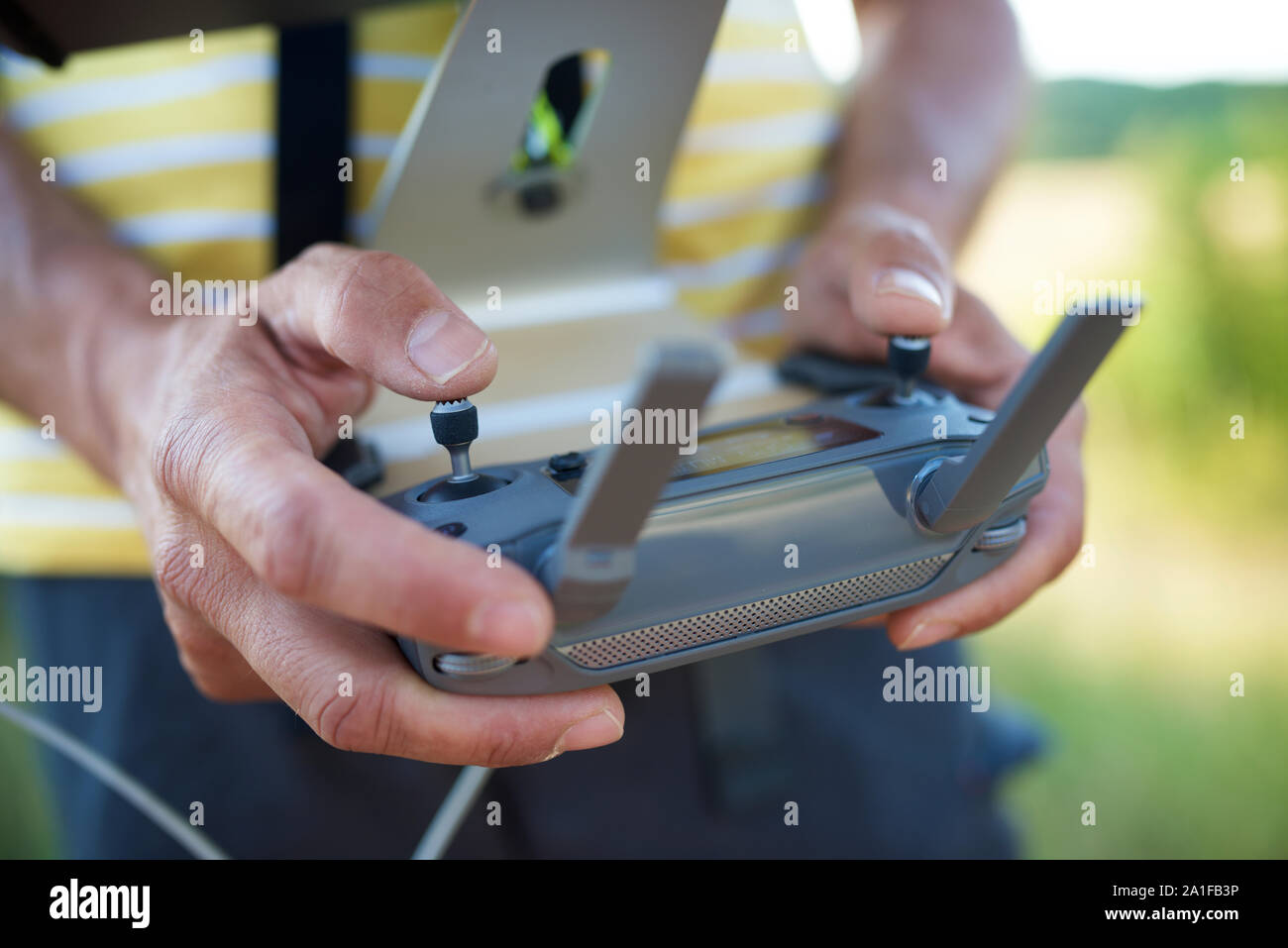 Close-up of a man driving the remote control of a drone. Stock Photo