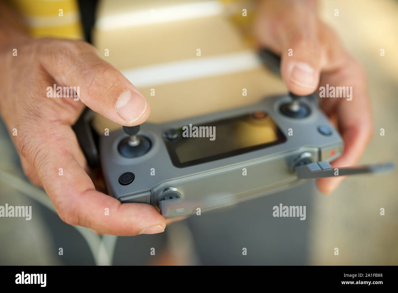 Close-up of a man driving the remote control of a drone. Stock Photo