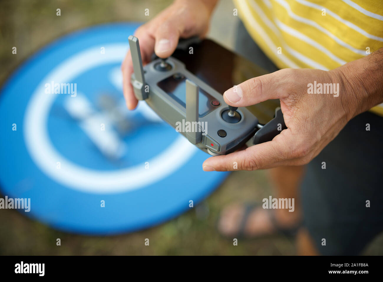 Close-up of a man driving the remote control of a drone. Stock Photo