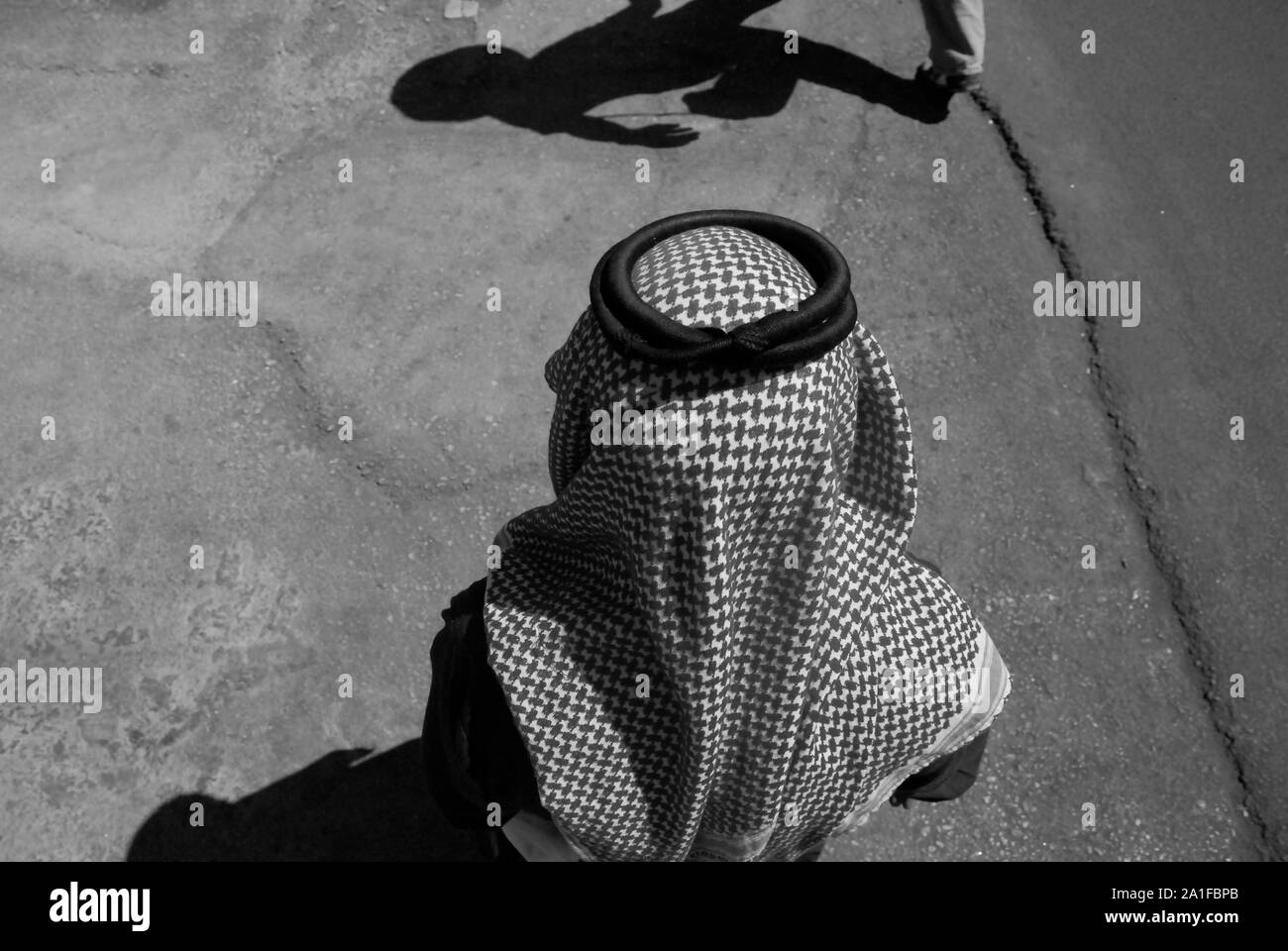 Muslim wearing Keffiyeh  in the streets of Kerak, Jordan Stock Photo