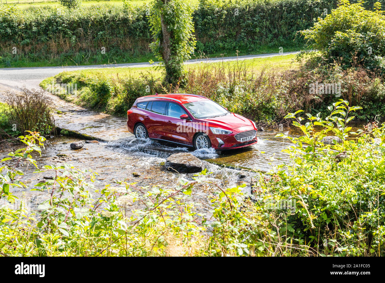 Exmoor National Park - A car crossing the ford over Badgworthy Water in the village of Malmsmead, Devon UK Stock Photo