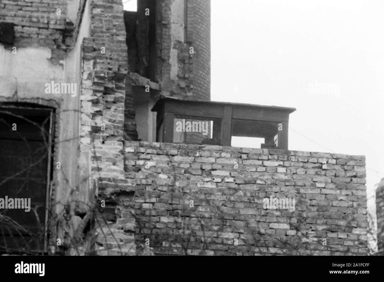 Hinter der Mauer sitzen Grenzposten in einem Wachhäuschen in Berlin, Deutschland 1962. Behind the wall border soldiers sitting in their booth at Berlin, Germany 1962. Stock Photo