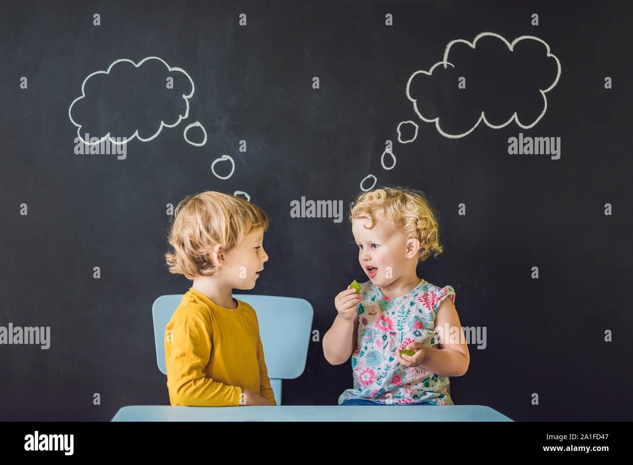 The boy and the girl are thinking, choosing. Stock Photo