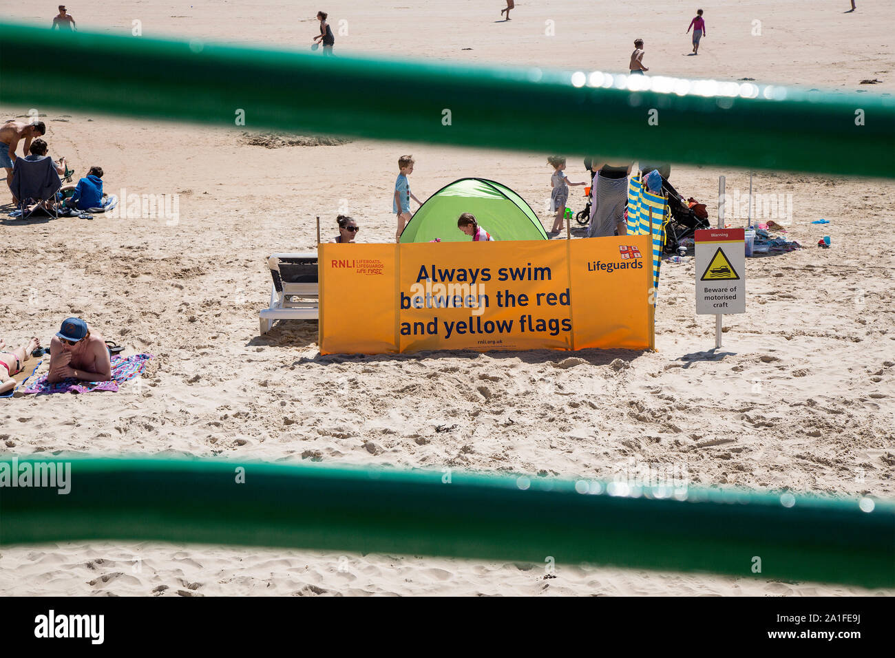 An RNLI lifeguard post on the beach fronting the colourful Winston