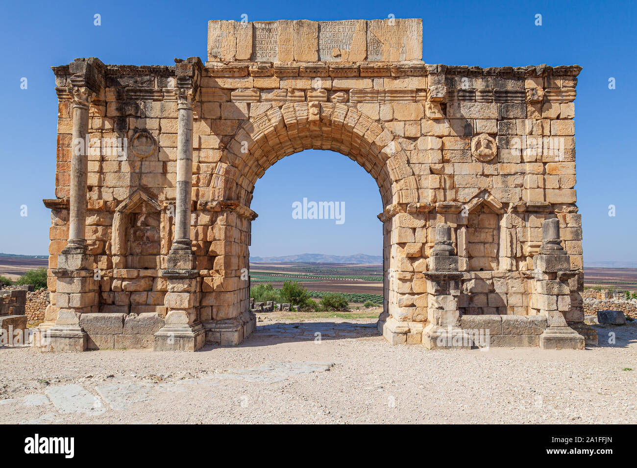 The Triumphal Arch devoted to Emperor Caracalla at the 3rd Century Ruins at Volubilis morocco Stock Photo