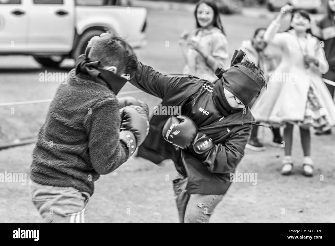 Miners Day celebrations at El Volcan village, Cajon del Maipo valley at the Andes. Blind kids boxing fight, a funny event during the party Stock Photo