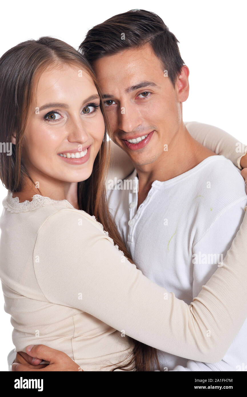Portrait of happy beautiful young couple posing on white background ...