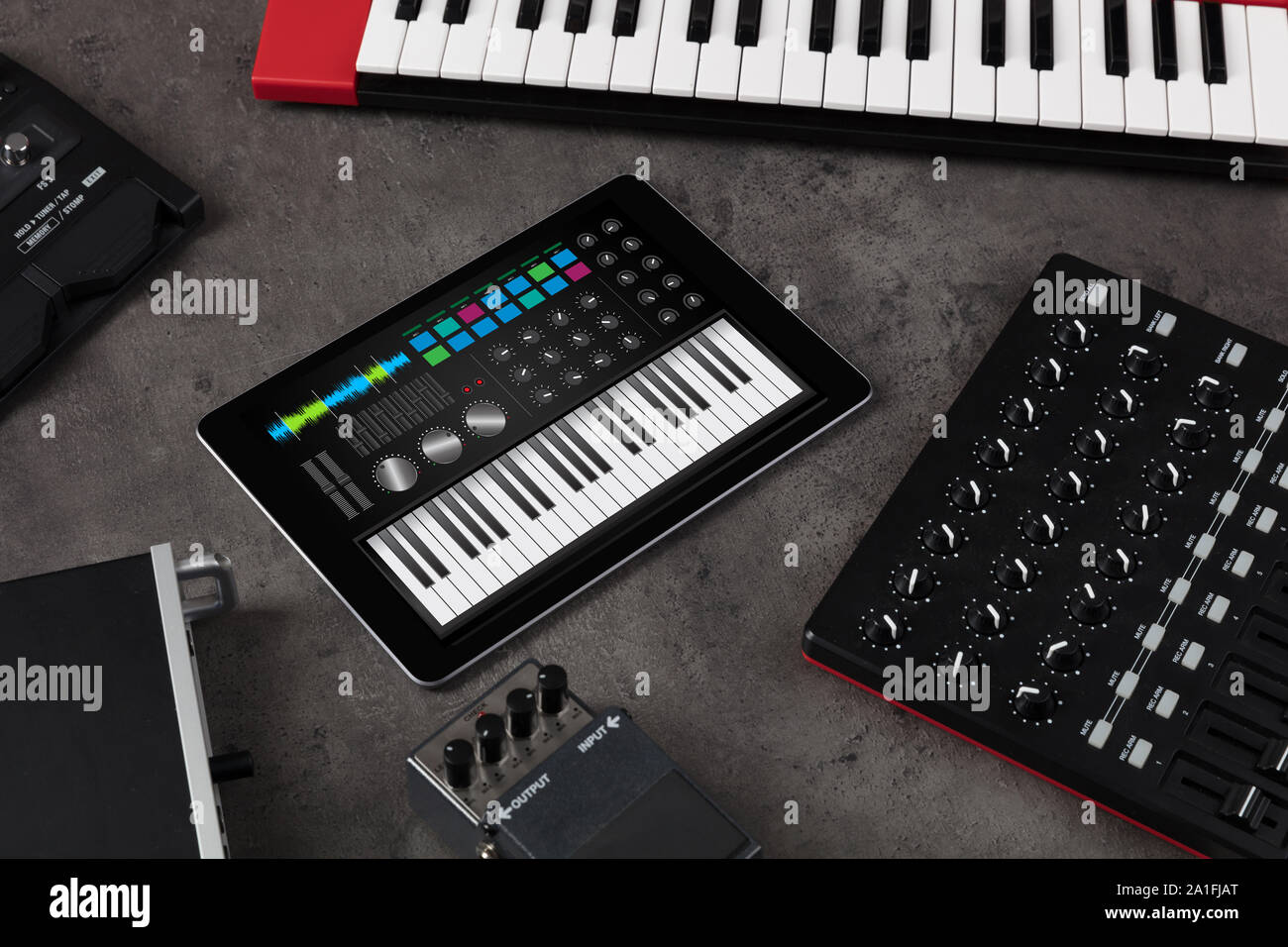 Piano synthesizer app on tablet and musical instrument concept Stock