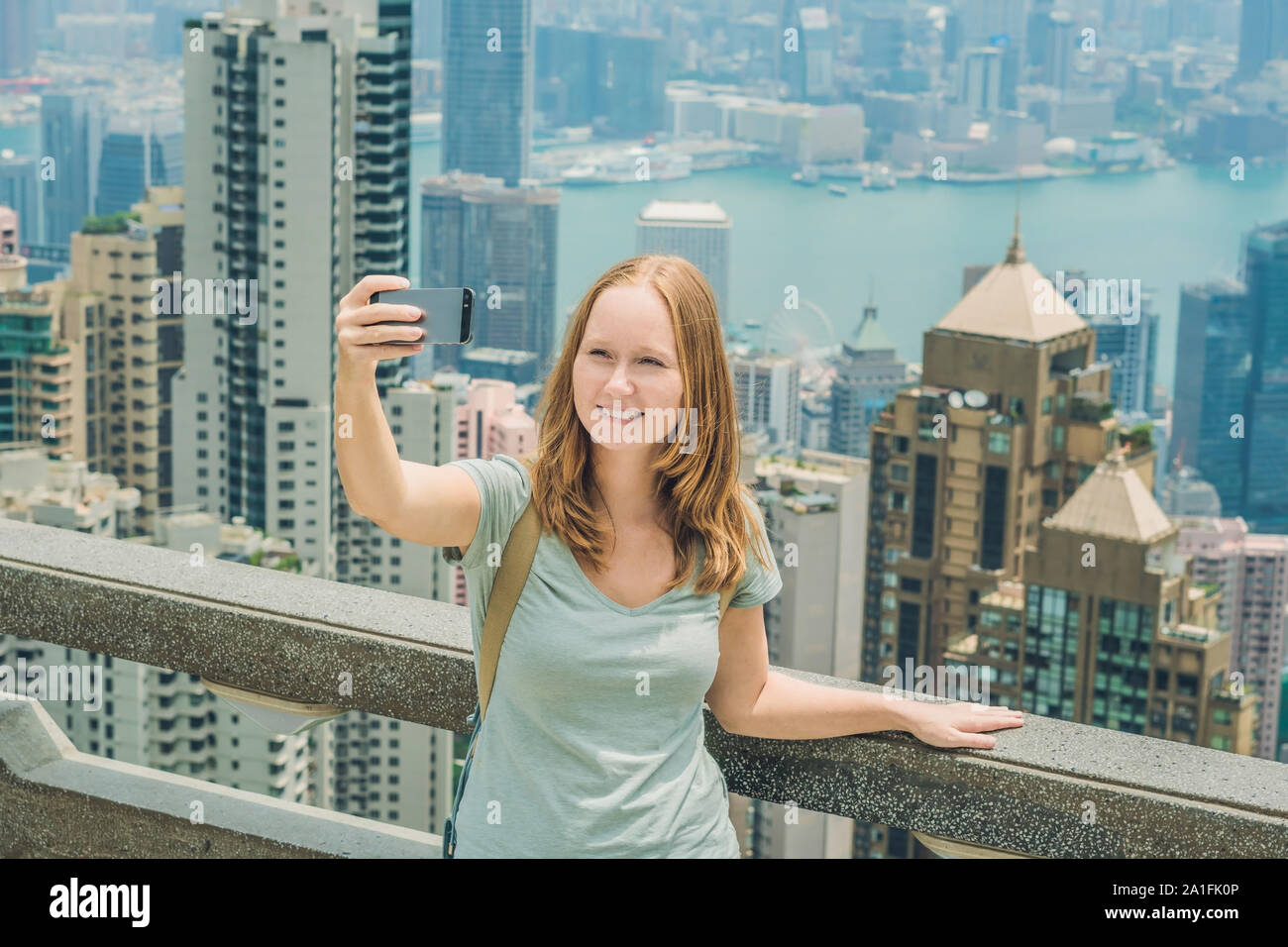 Hong Kong Victoria Peak woman taking selfie stick picture photo with ...