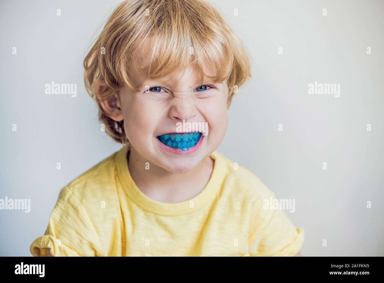 Three-year old boy shows myofunctional trainer to illuminate mouth  breathing habit. Helps equalize the growing teeth and correct bite.  Corrects the po Stock Photo - Alamy