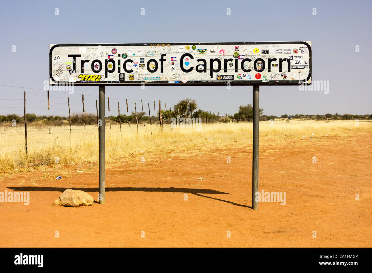 Tropic of Capricorn road sign on a dry and dusty Namibian desert road in Winter with no people Stock Photo
