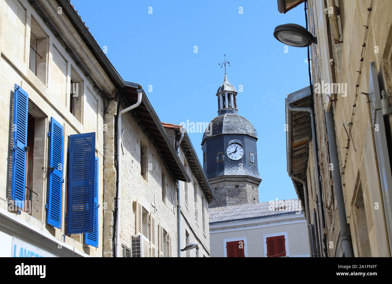 Quaint backstreets and clock tower of the town of Melle in the region of Deux Sevres in western France. Stock Photo
