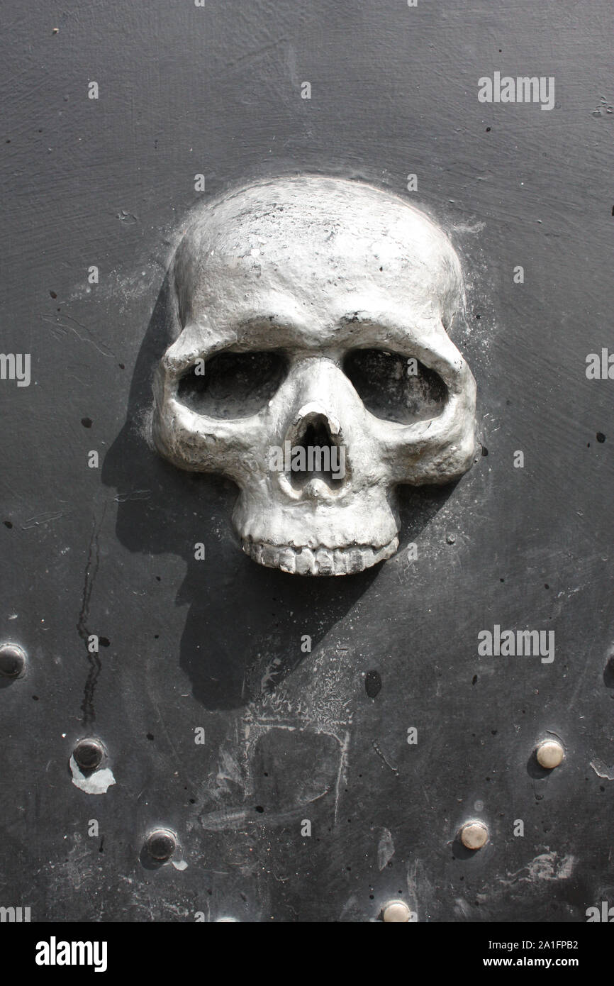 Metal skull door, fishing district of Genoa, Italy Stock Photo