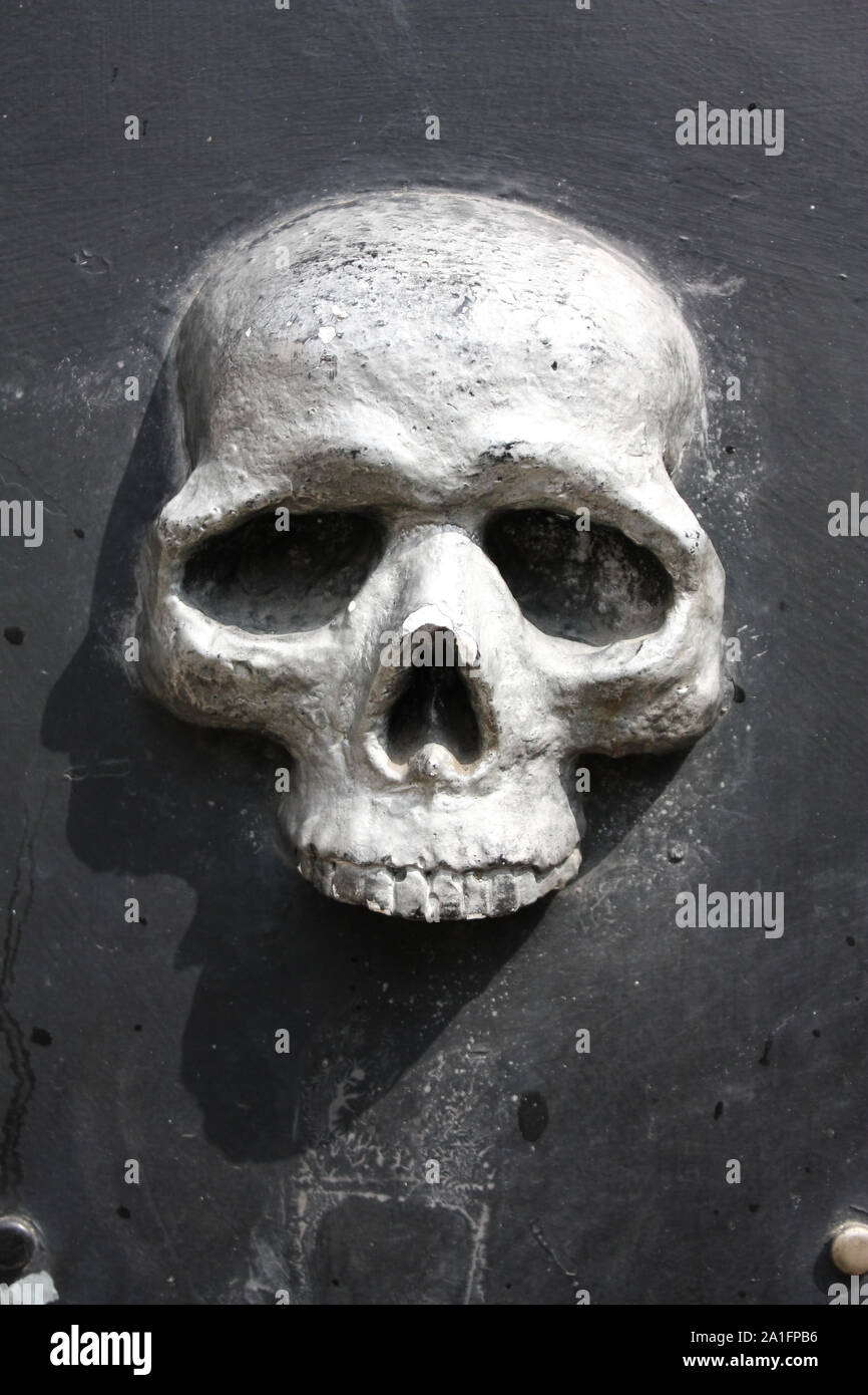 Metal skull door, fishing district of Genoa, Italy Stock Photo
