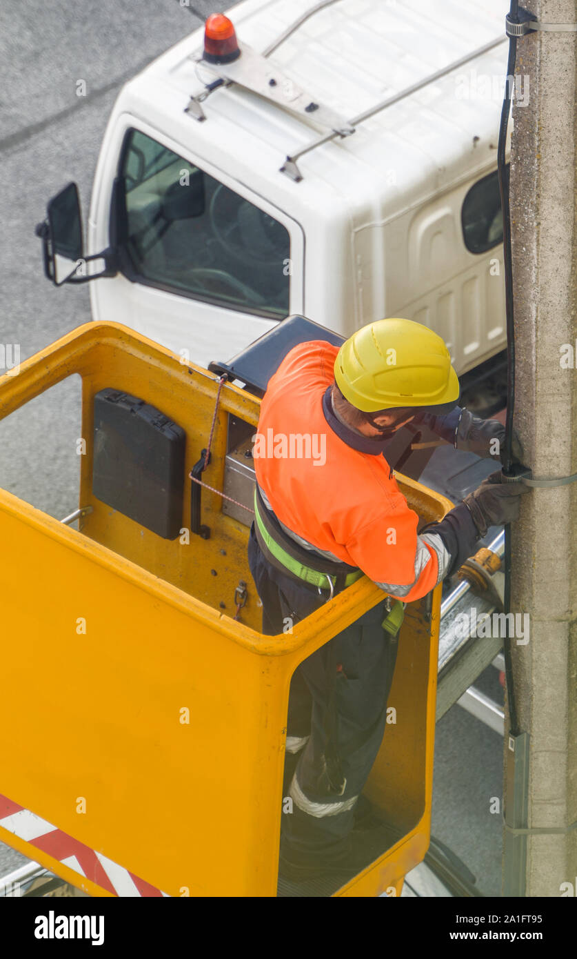 Electrician working in the mobile crane basket Stock Photo Alamy