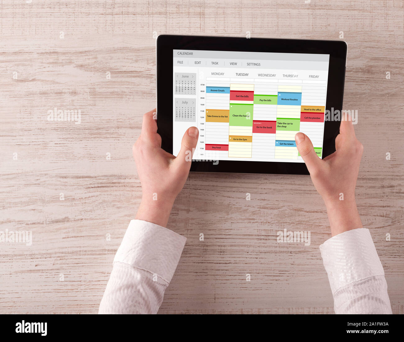 Hand holding tablet with timetable and calendar concept Stock Photo - Alamy