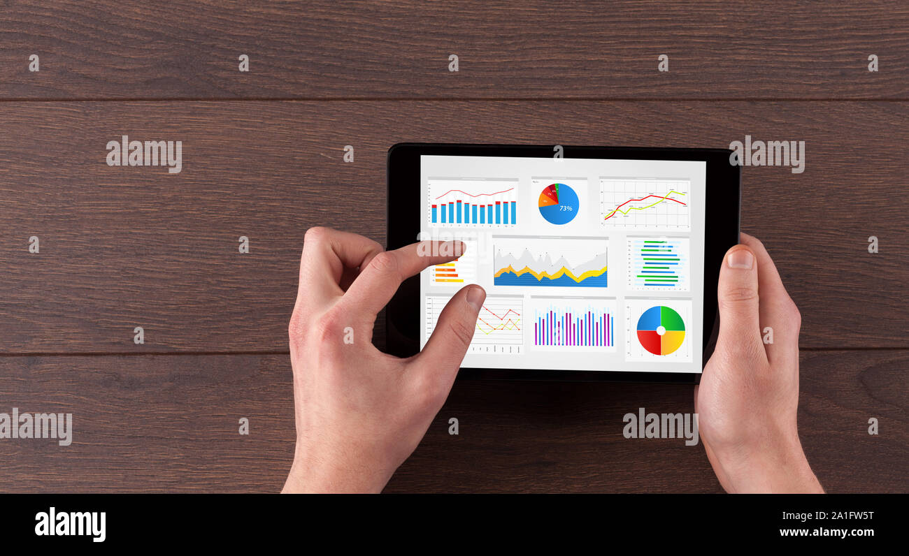 Hand making diagrams and charts on tablet Stock Photo - Alamy
