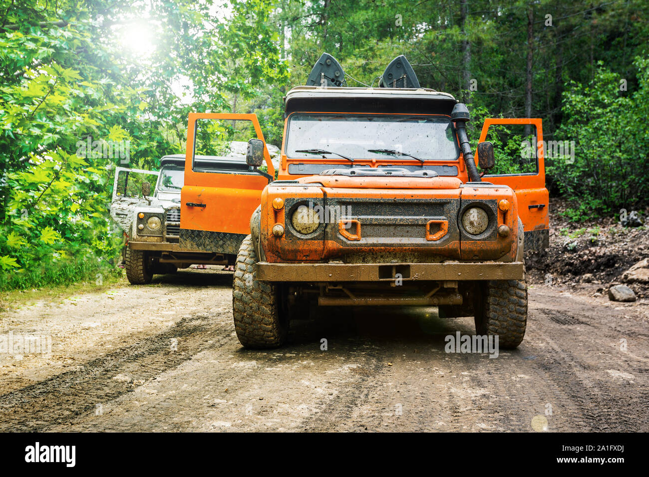 Dirty Four wheel drive truck 4x4 with all terrain tires parked in the forest Stock Photo