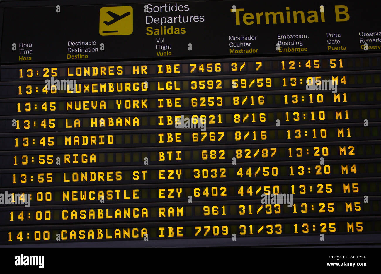An electronic airport airplane departures board with times and destinations. Stock Photo