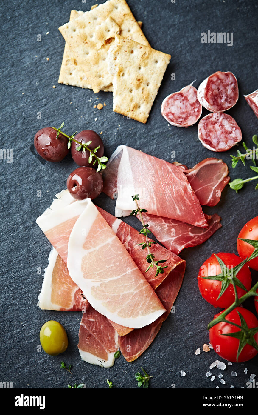 Mediterranean antipasto on a black slate Stock Photo Alamy