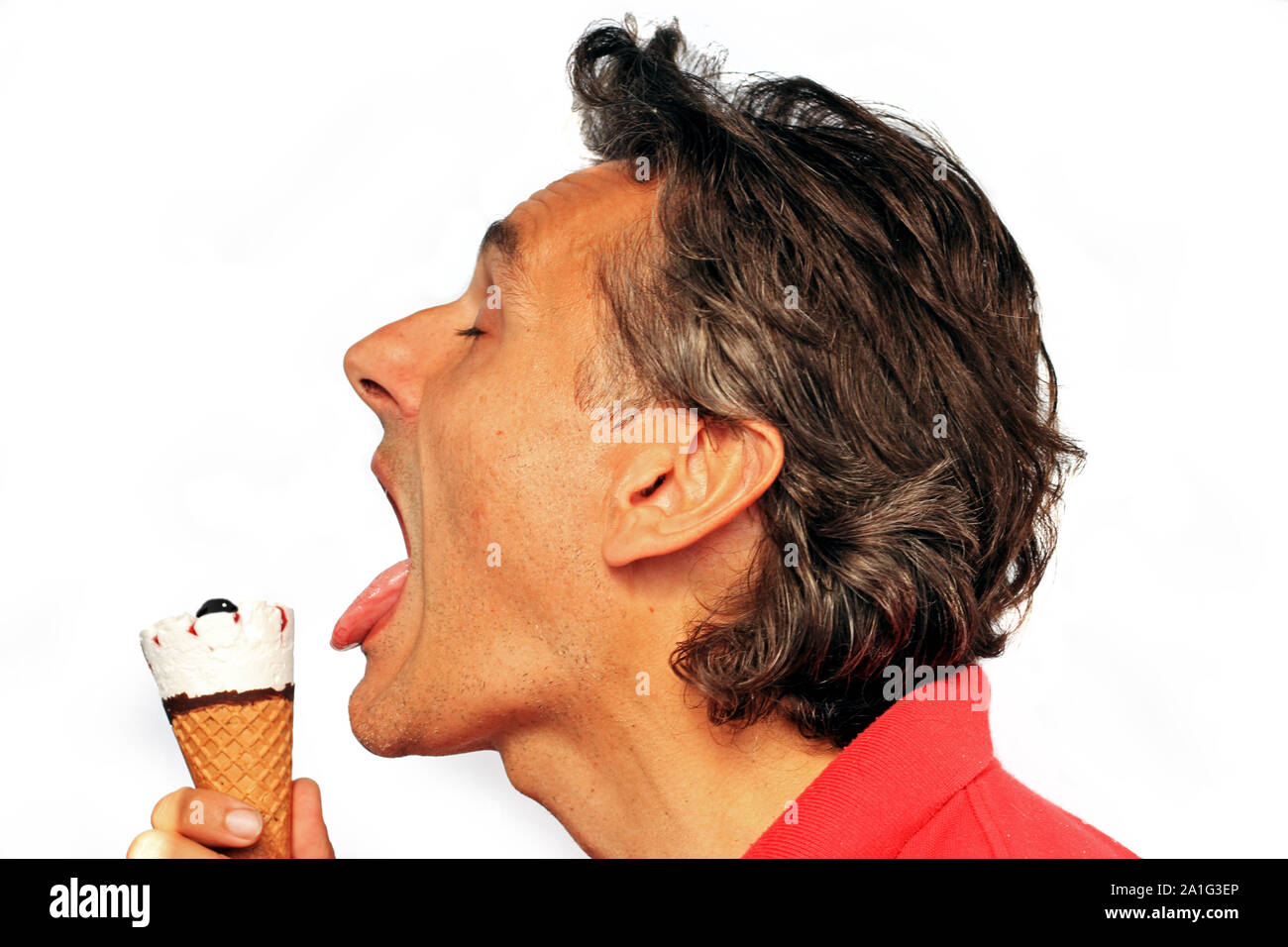 man eating ice cream cone over white background Stock Photo Alamy