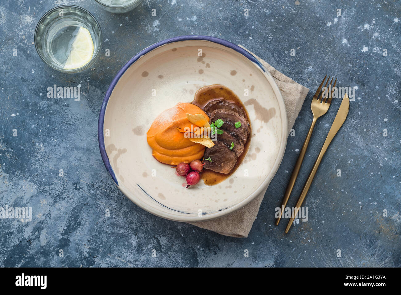 Slow braised lamb with sweet potato puree, restaurant dish, copy space. Stock Photo