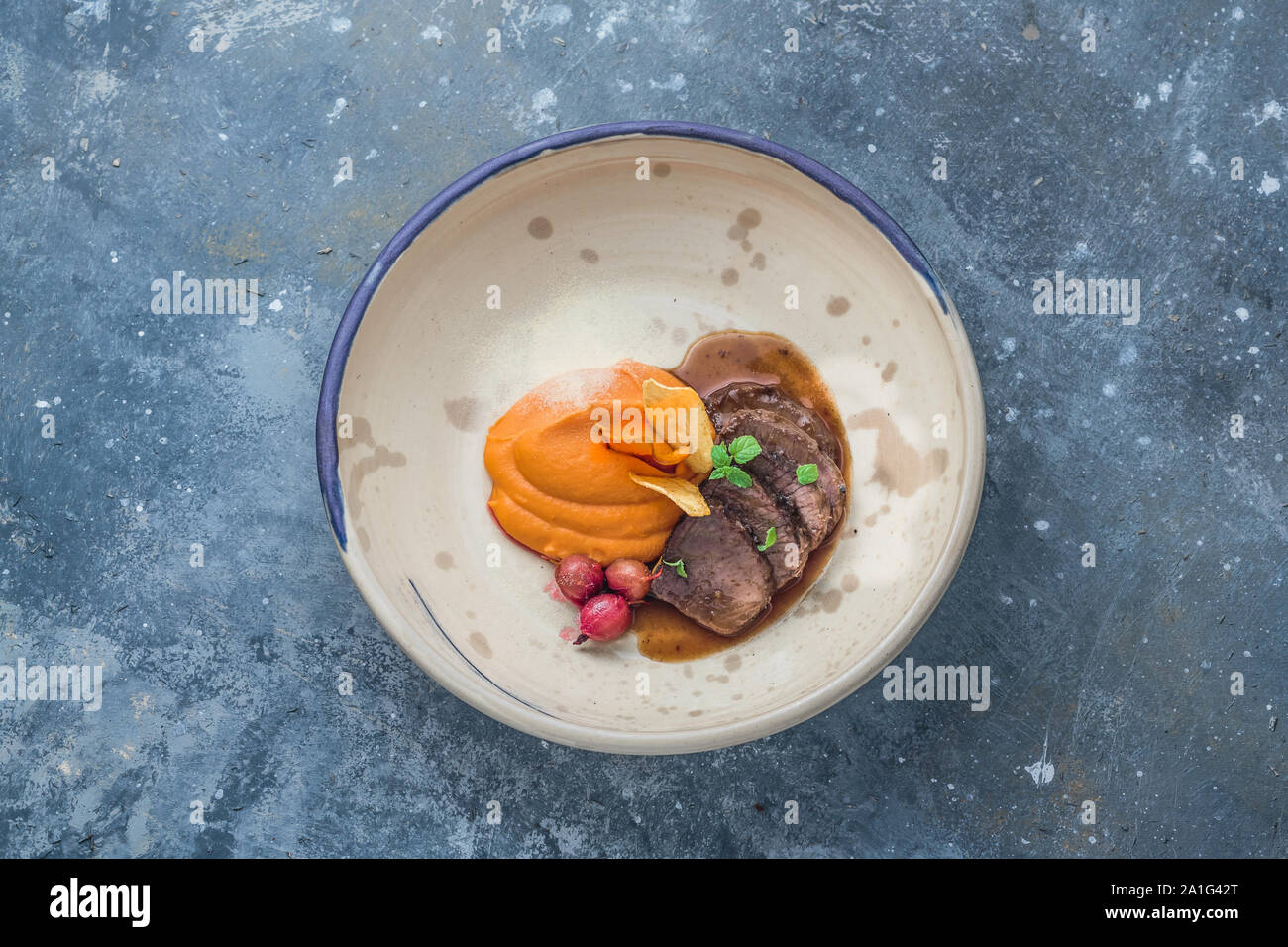Slow cooked lamb with sweet potato puree, restaurant dish, copy space. Stock Photo