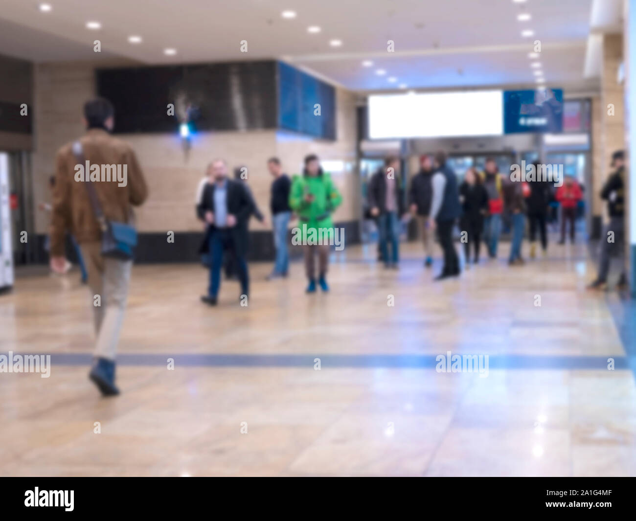 People walking in an underground passage. Silhouettes of passengers on blur. Blurred image of moving people. Stock Photo