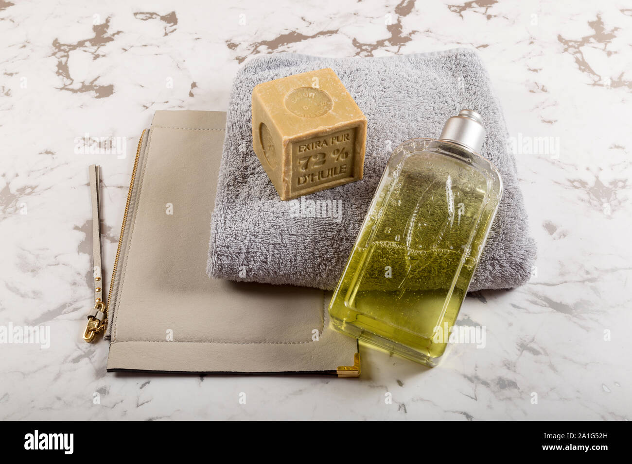 Spa/wellness arrangement, mood for wellnes farm, first class spa, hotel, etc. Soap, cosmetic pouch, towel and bath addicitve on marble underground. Stock Photo