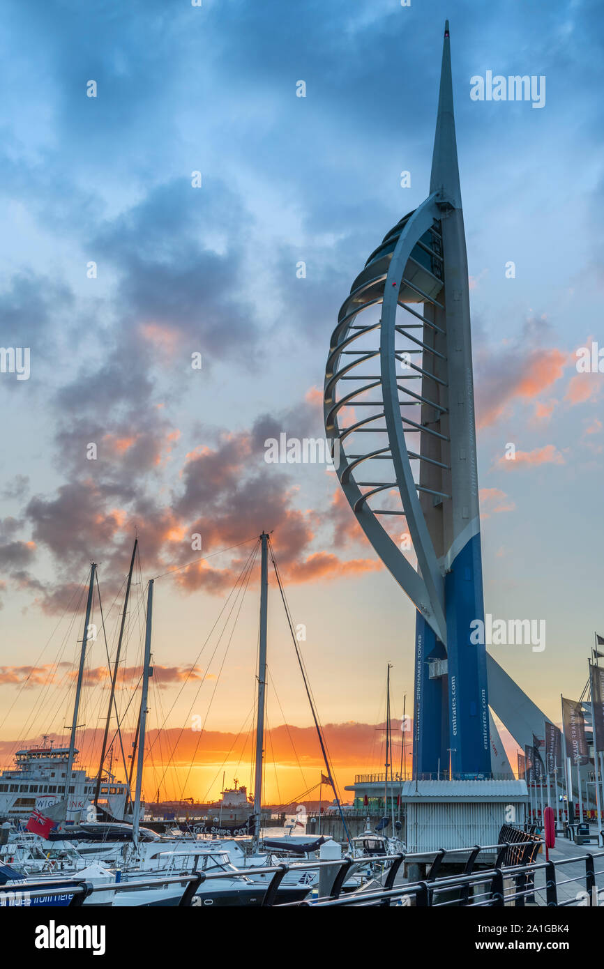 After a hot and humid day on the Hampshire coast, the lights come on at Gunwharf Quays as the sun sets over Portsmouth Harbour on the Solent and the f Stock Photo