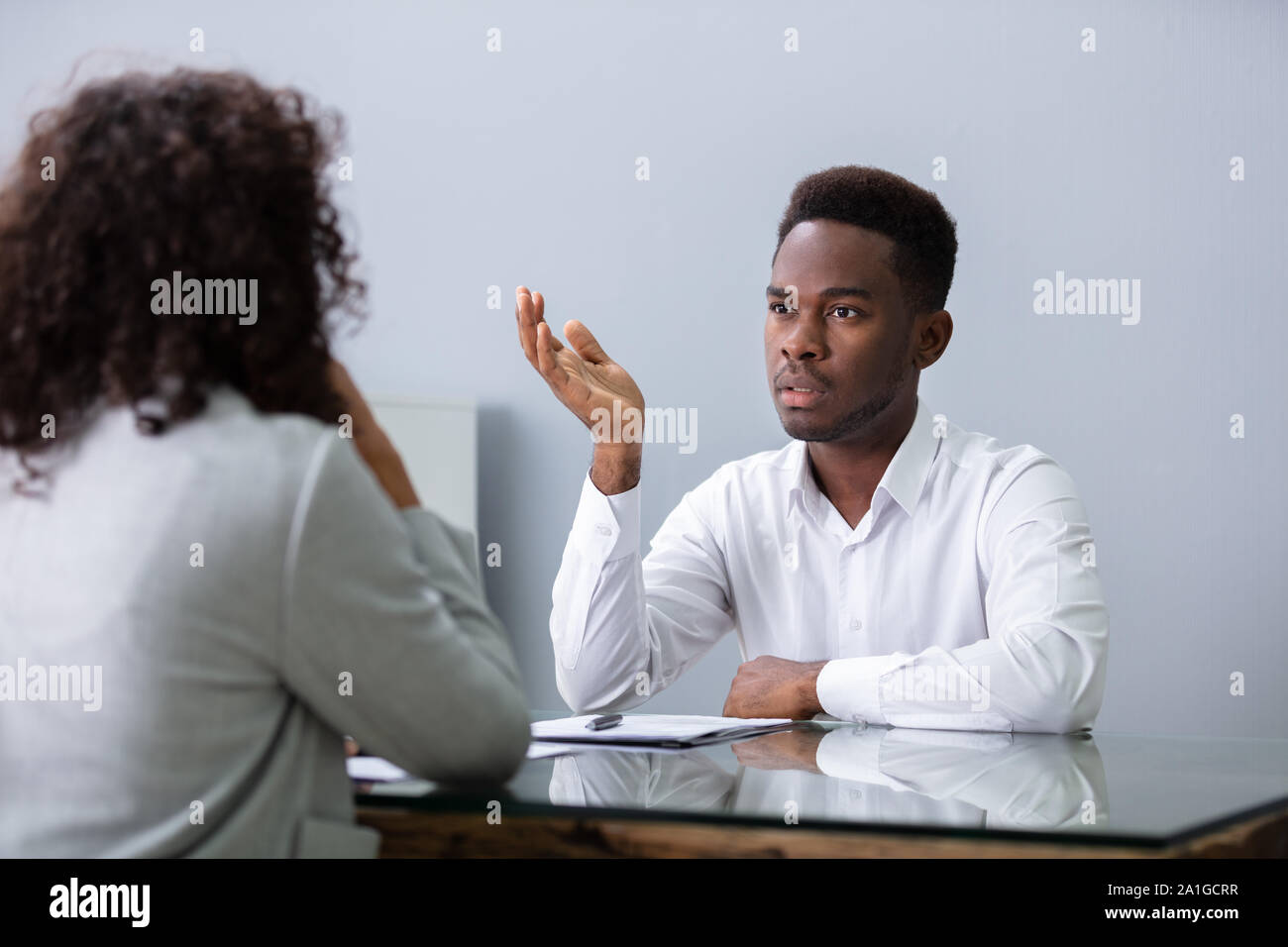 Stressed Young Business Man Failing Hard Interview In Office Stock Photo