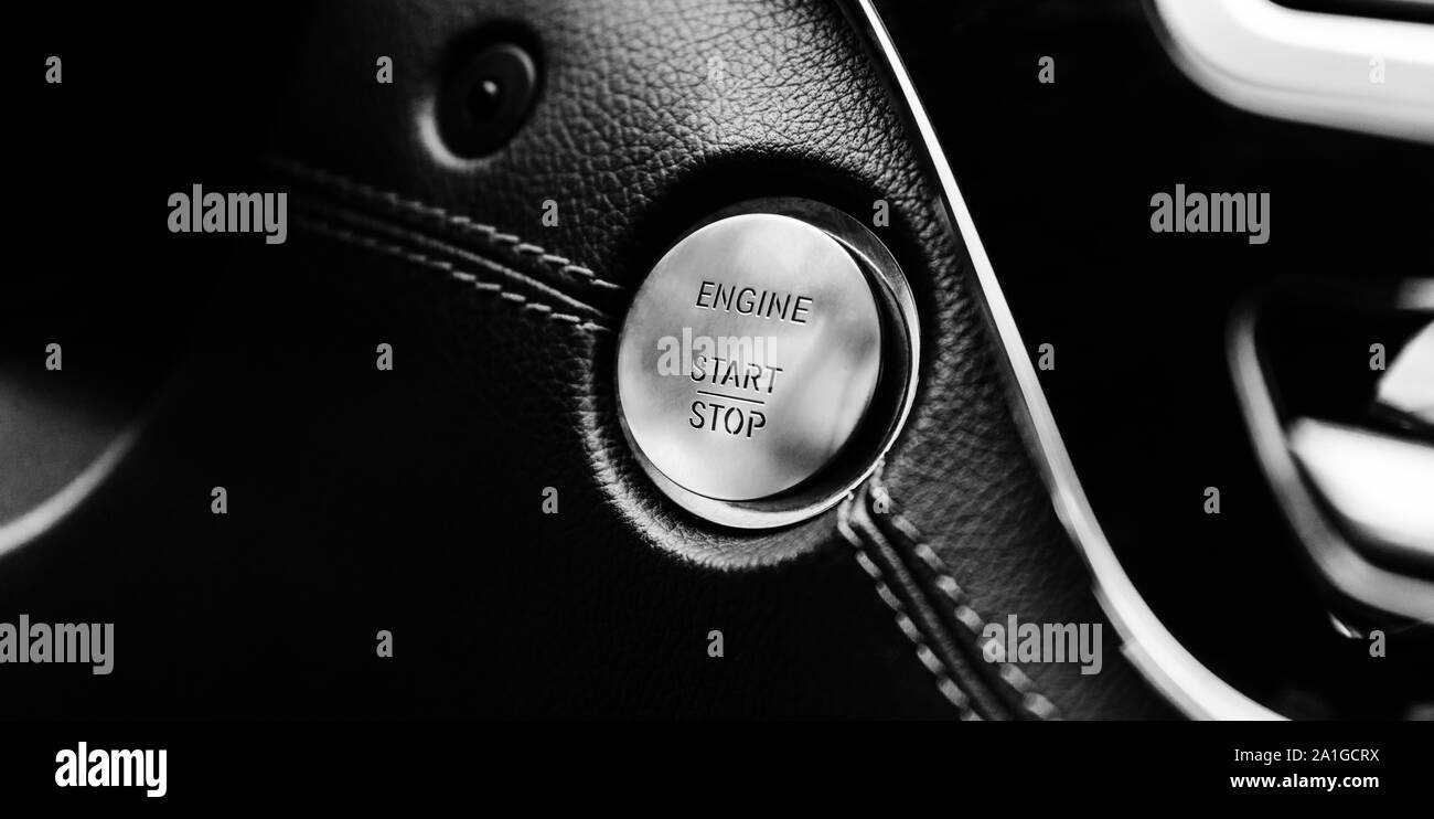 start-stop button engine on a leather base of a business car with shallow depth of field Stock Photo
