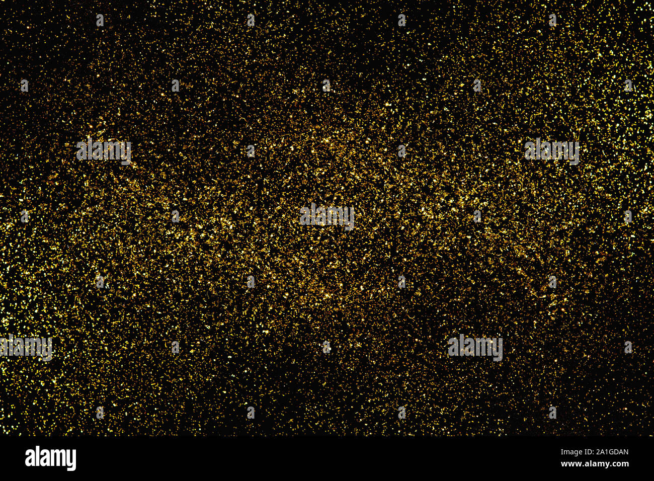 Abstract blurred glitter bokeh background in gold, on black Stock Photo